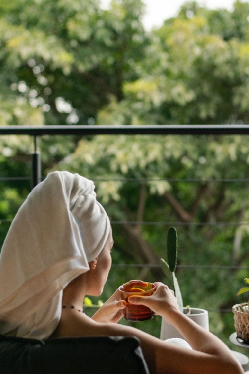 Woman relaxing with a warm detox drink in nature