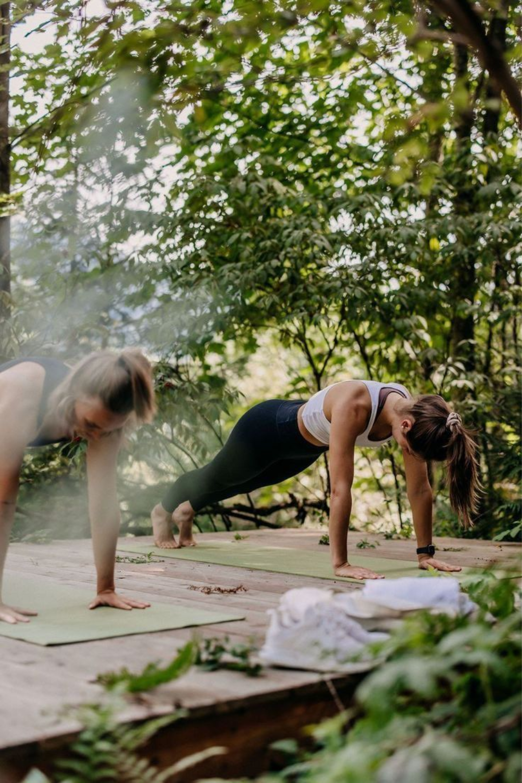 Women exercising outdoors in a forest setting