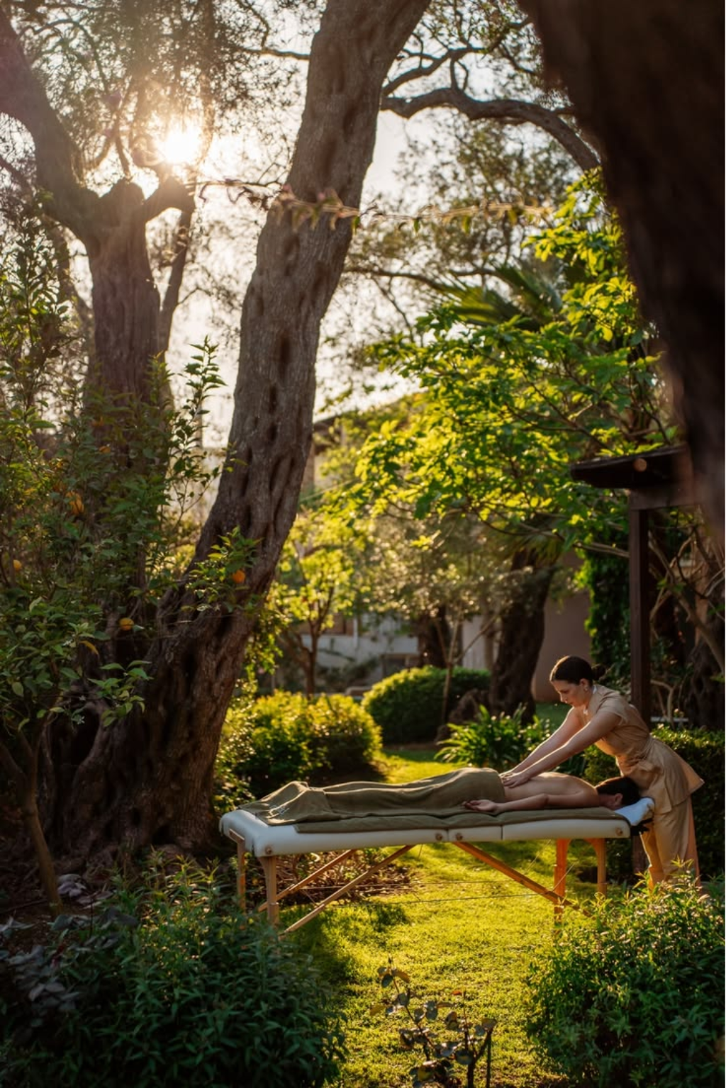 Outdoor massage treatment in a sunlit healing garden